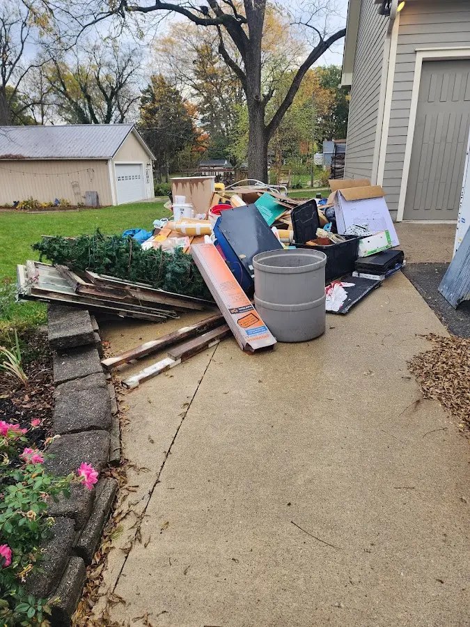 Dumpster being loaded with debris for Roofing Dumpster Rental in Geneseo